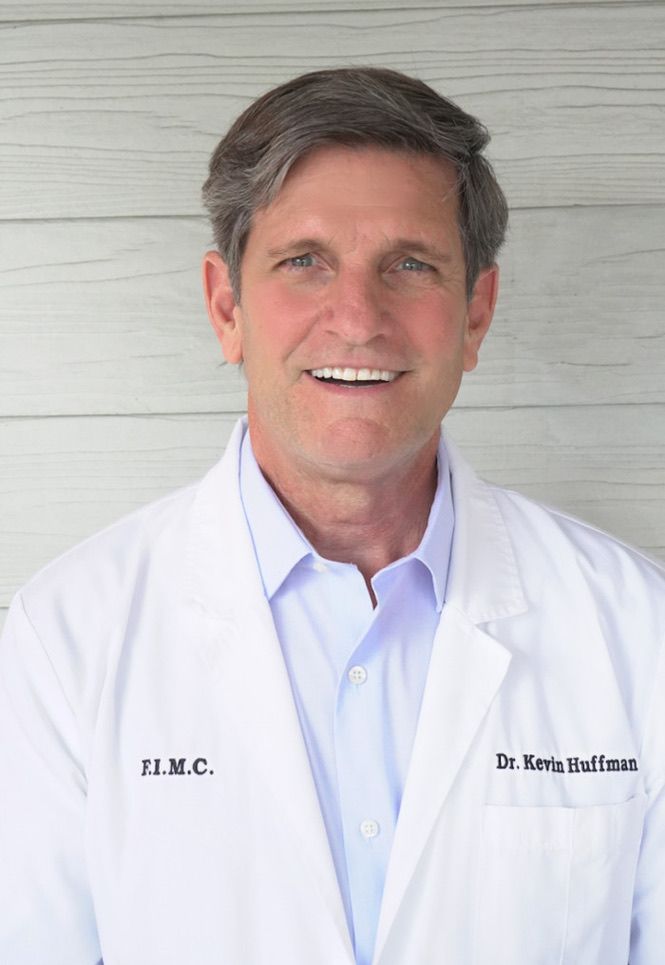 Dr. Kevin Huffman, DO picture of Dr. Kevin Huffman smiling and wearing a medical jacket