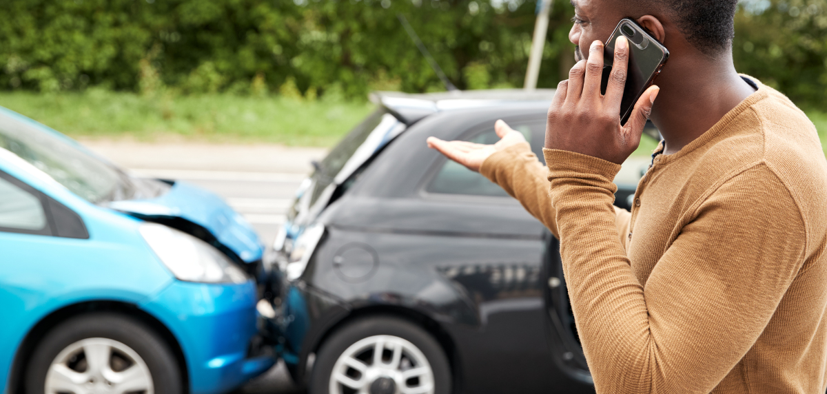 Rear end car accident in Florida with involved driver calling someone on his cell phone.