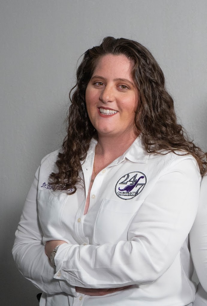 Photo of Dr. Kiani Segree, chiropractor at Spring Hill Medical Injury Center: 247 Chiropractic Wellness and Rehab, posing with a smile and arms folded in front of her.