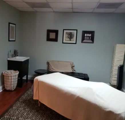 Massage table in a dimly lit room where massage therapy takes place at Brandon Medical Injury Center: Brandon Spine & Injury Center