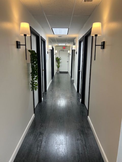 View down long hallway with doors on both sides at St. Petersburg Medical Injury Center: Rainey Chiropractic