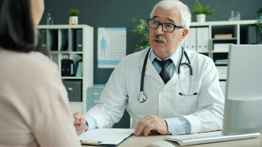 Physician speaking with a patient during a medical consultation